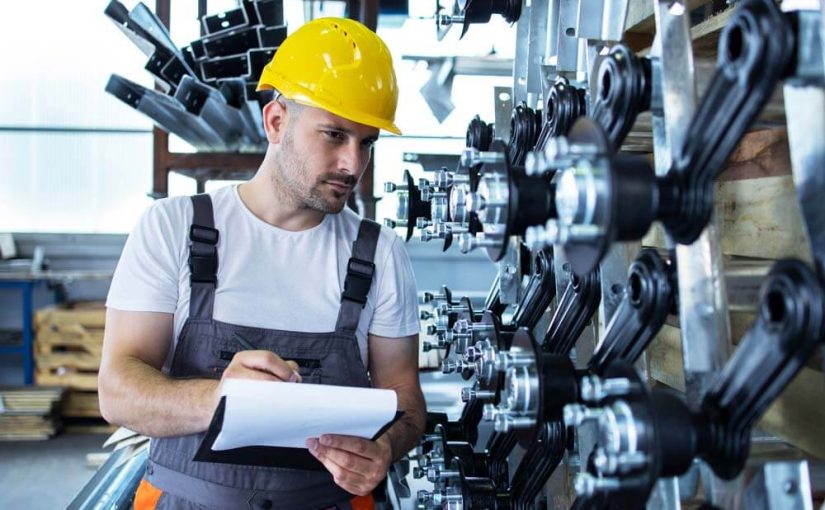industrial-employee-wearing-uniform-yellow-hardhat-checking-production-factory