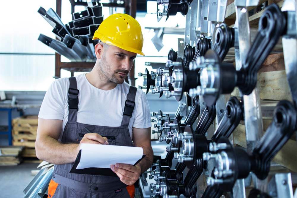 industrial-employee-wearing-uniform-yellow-hardhat-checking-production-factory